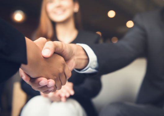 This is an image of sales people shaking hands